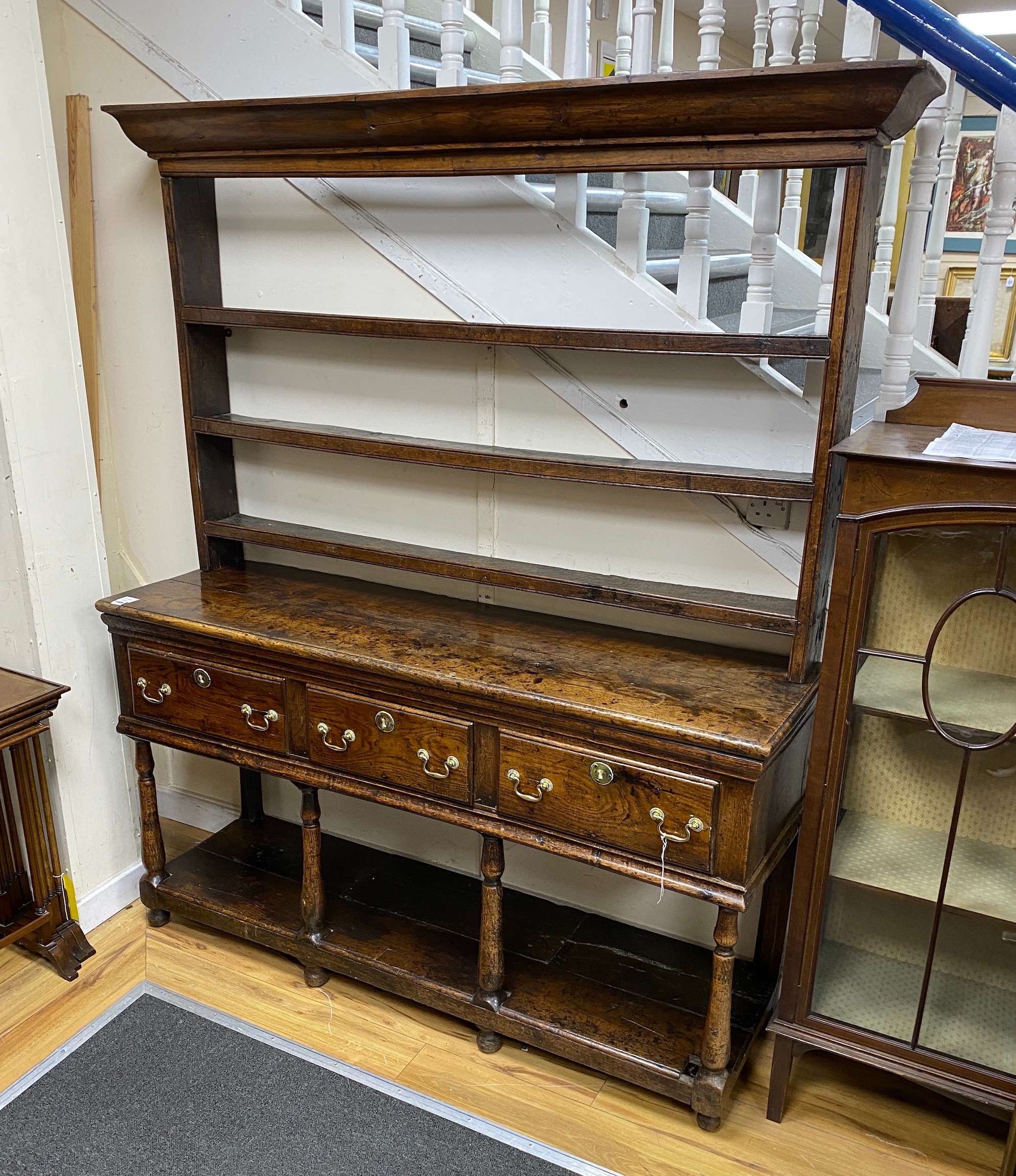 A mid 18th century oak potboard dresser, with an open shelved rack, over four drawers, width 158cm, depth 45cm, height 190cm